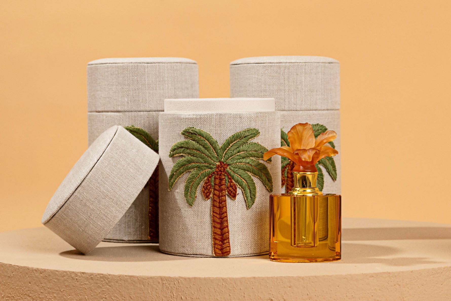 Al Sultan Palm bespoke cylindrical keepsake box with palm tree embroidery and crystal oud bottles by Atelier Carrousel