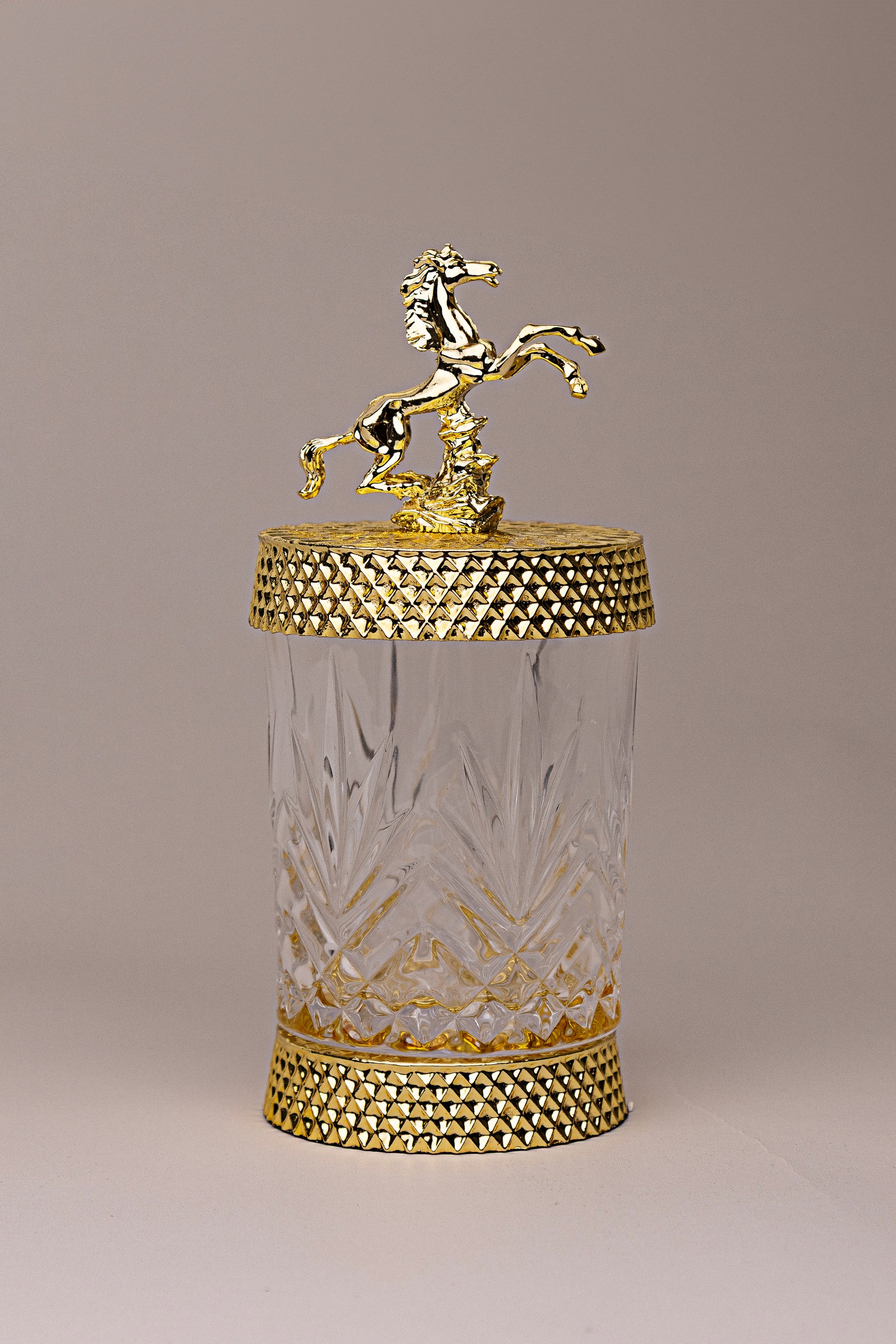 Equestrian Jewel luxury glass jar with gold detailing and golden horse sculpture lid by Atelier Carrousel
