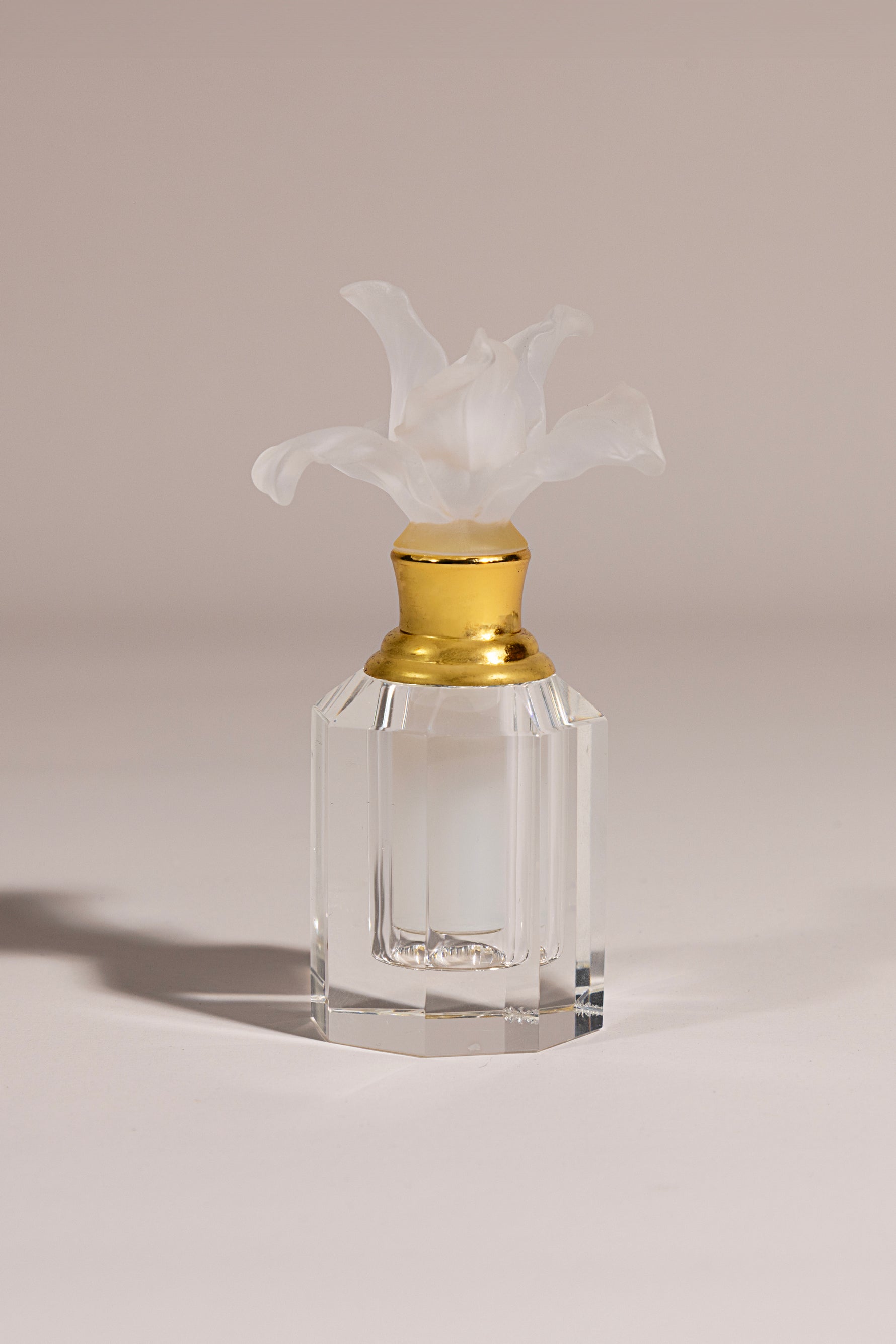 Loulwa luxury crystal oud bottle with frosted bloom and golden neck on octagonal base by Atelier Carrousel