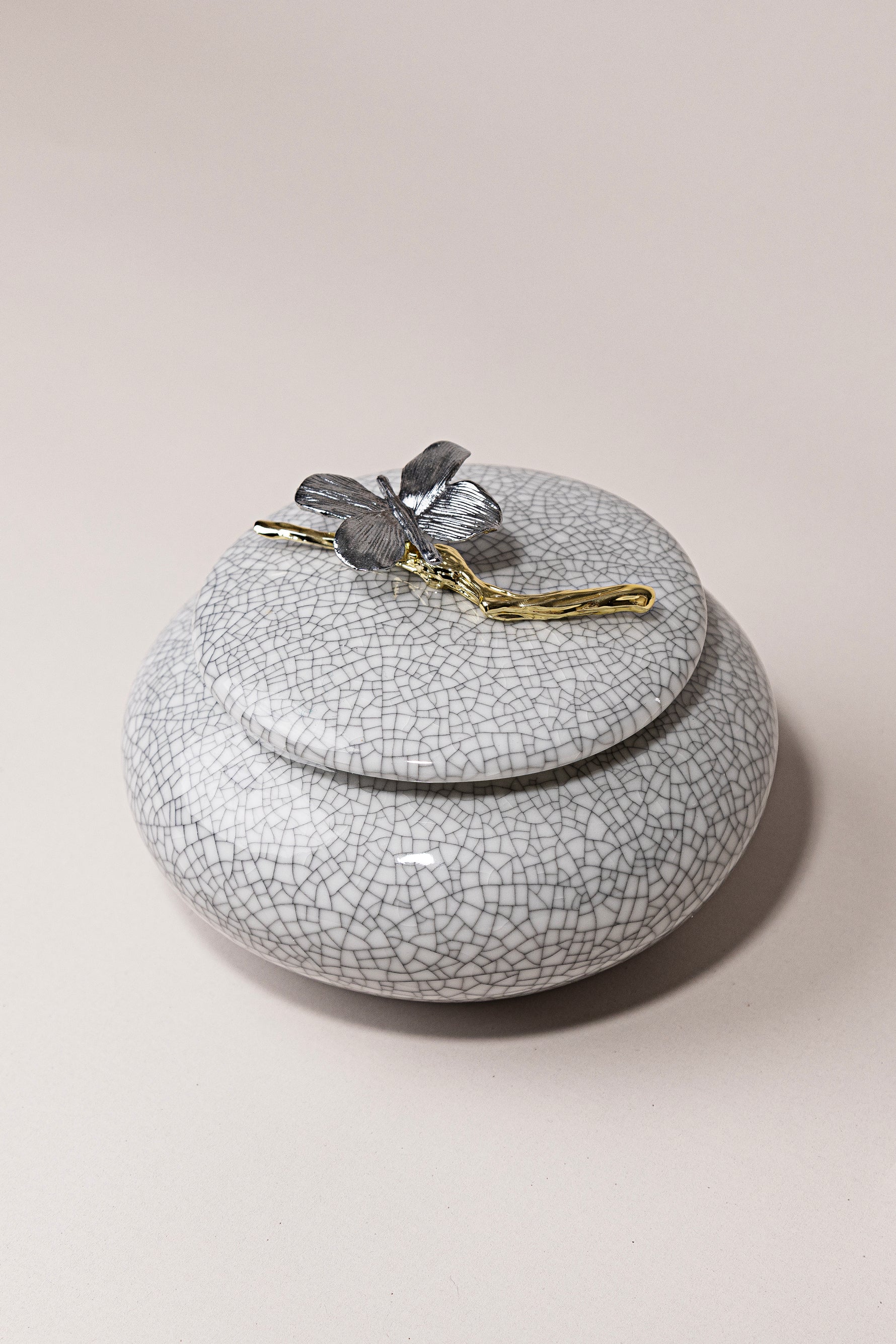 Porcelain Muse luxury porcelain jar with butterfly and branch detail in metallic tones by Atelier Carrousel