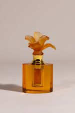 Whisper Bloom luxury oval crystal oud bottle with delicate floral detail by Atelier Carrousel