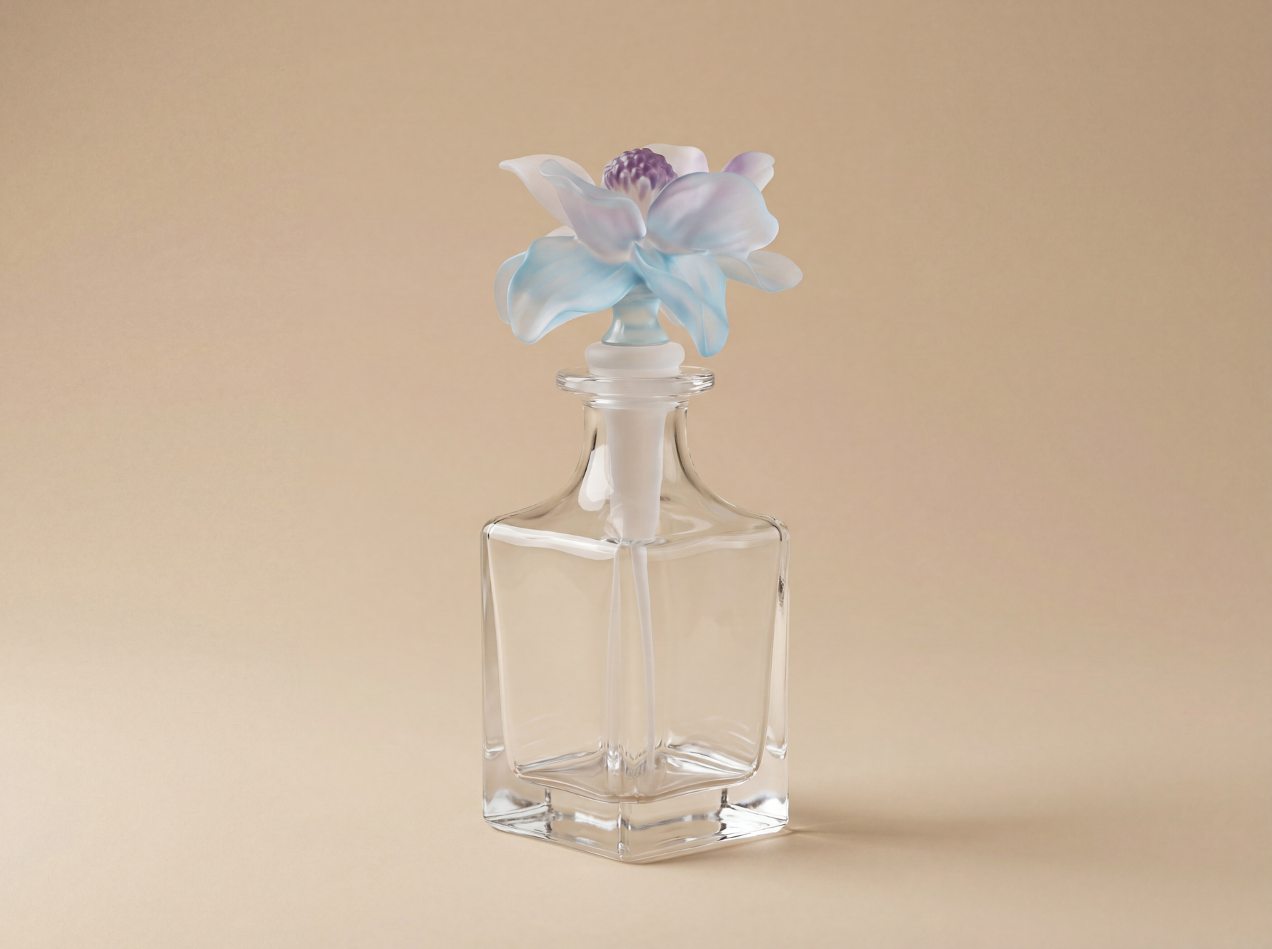Nassim luxury glass bottle with blue purple sculpted floral cap by Atelier Carrousel